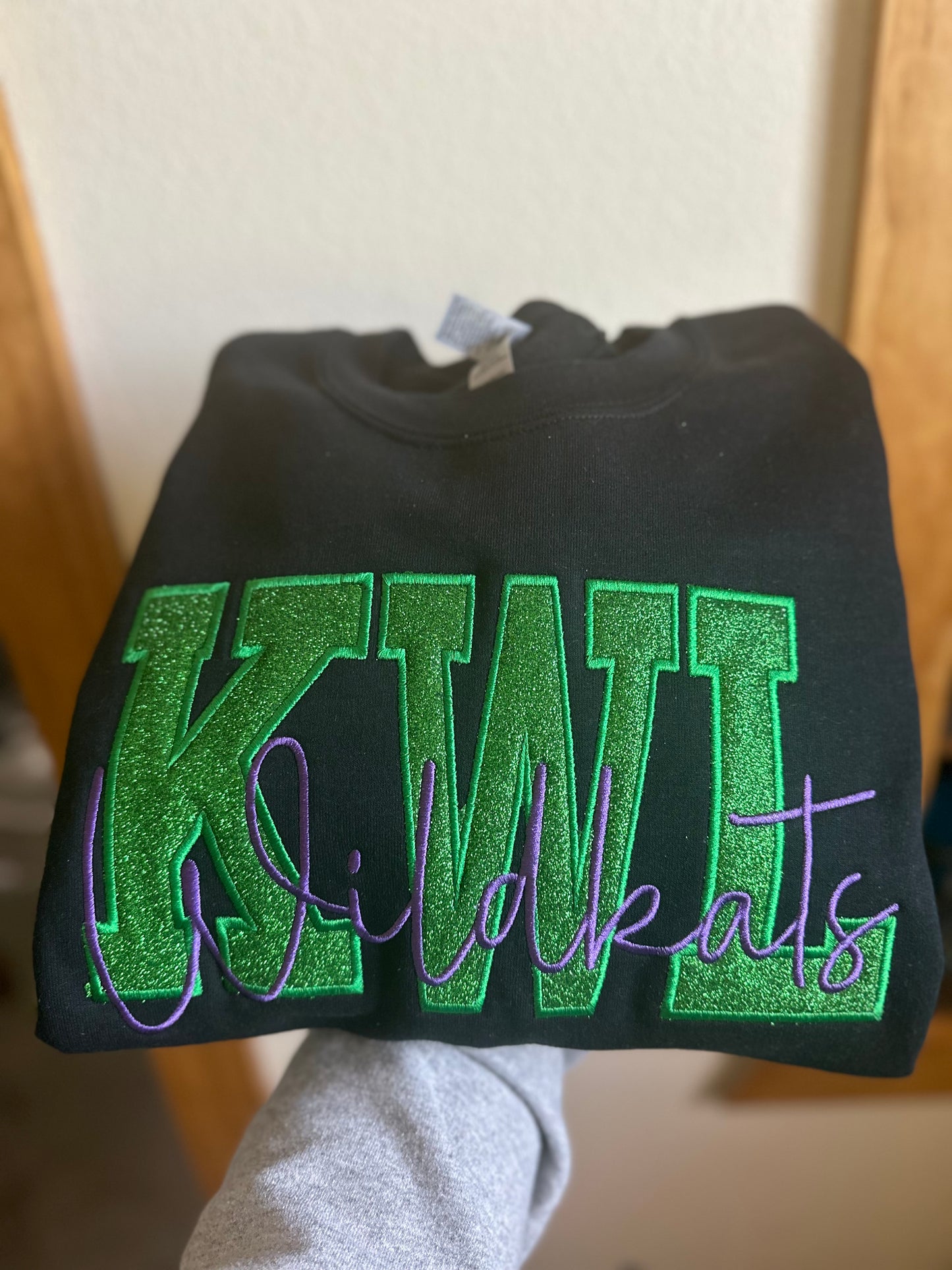 KWL Wildkats embroidered design available in short sleeve, crewneck, and hooded sweatshirt styles